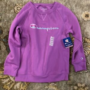 Children’s magenta long sleeved sweatshirt by Champion. Size large.NWT.